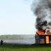 Firefighters spray a small structure engulfed in flames during a training exercise and controlled burn in 6700 block of Warner Rd. in Pittsfield Township on Thursday, May 9, 2013. Melanie Maxwell I AnnArbor.com